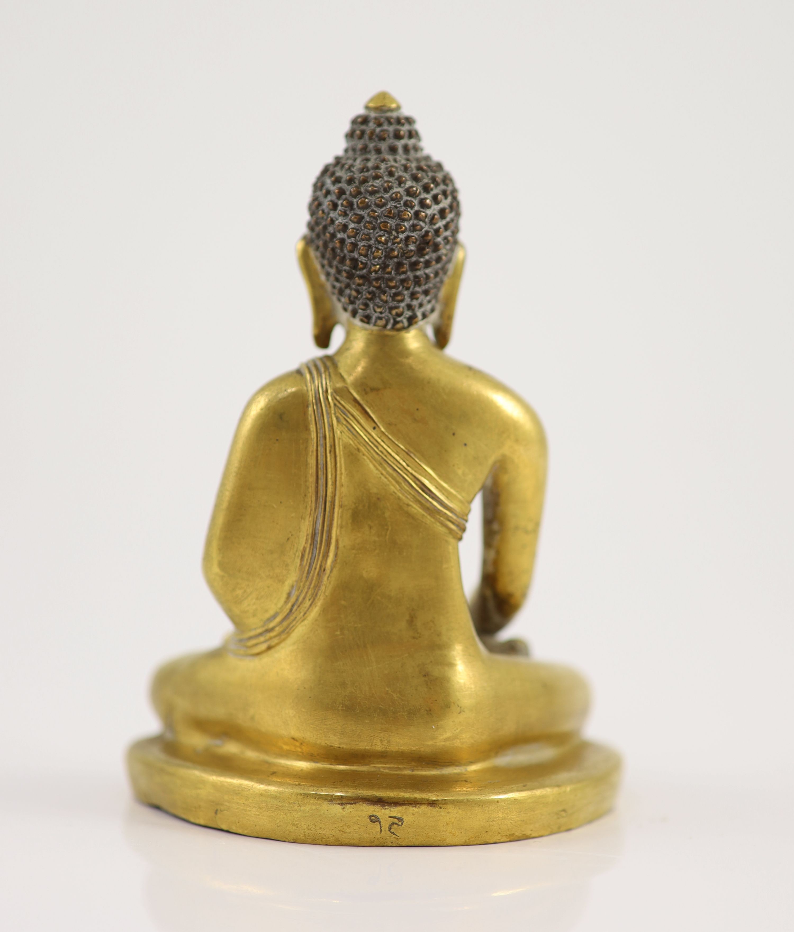 A Tibetan gilt copper alloy seated figure of Buddha Shakyamuni, 18th century, 13cm high